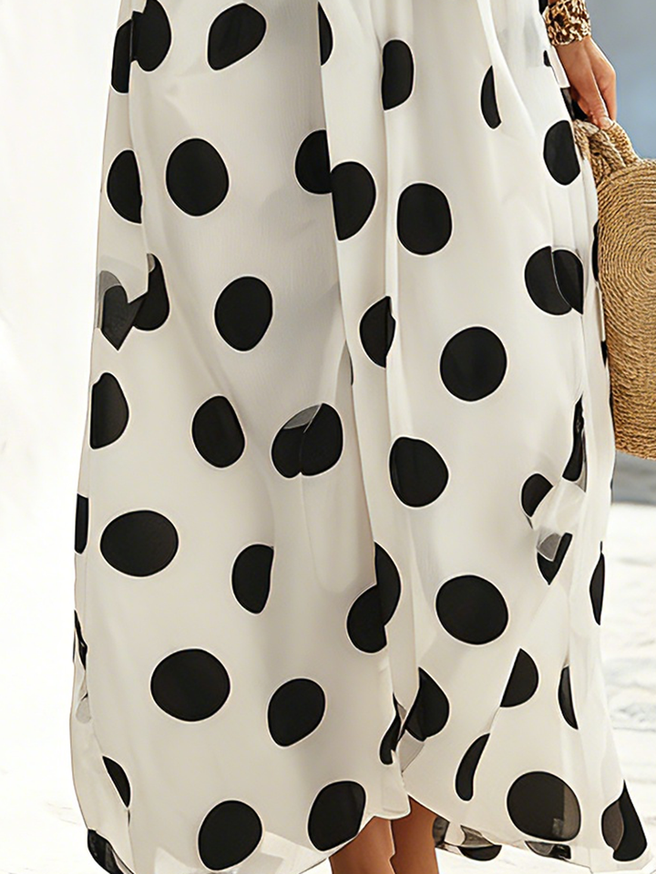 Maxi dress with black and white polka dots, seaside resort style, off-the-shoulder neckline