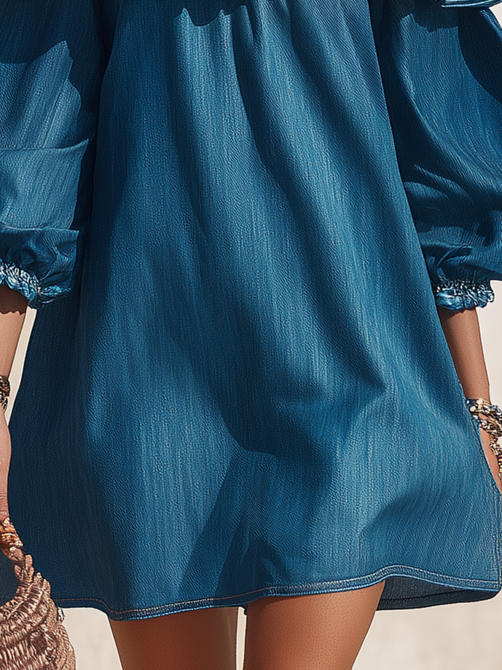 Resort style ruffled denim mini dress with off the shoulder and three-quarter sleeves