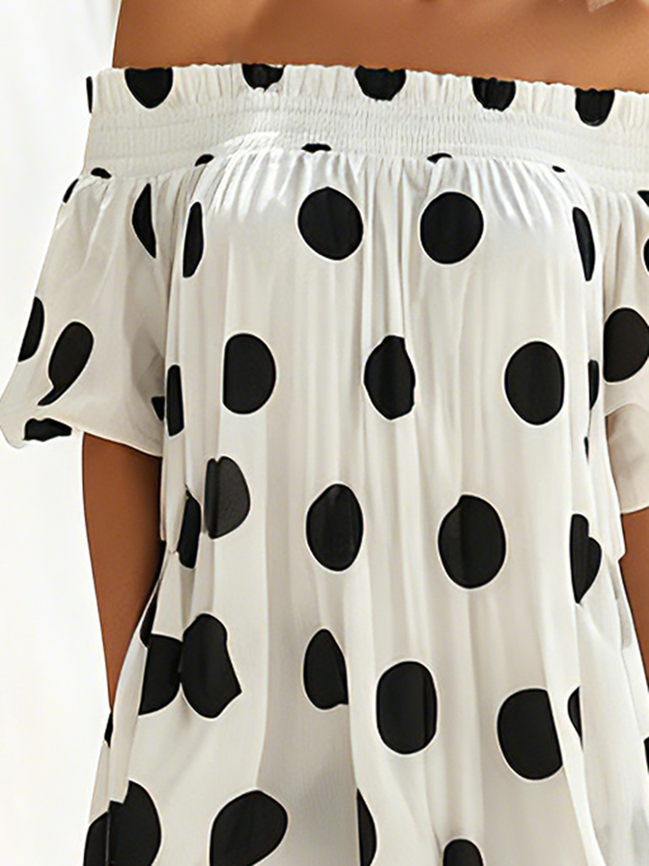 Maxi dress with black and white polka dots, seaside resort style, off-the-shoulder neckline